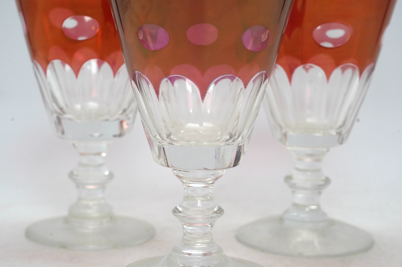 Twelve red lustre cut glass, stemmed wine glasses. 15cm high. Condition - fair to good